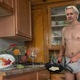 Wikileaks founder Julian Assange standing shirtless in a dirty kitchen inside the Ecuadorian embassy.
